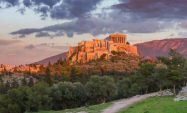 Acropolis of Athens at sunset with the Parthenon overlooking the city, iconic landmark of an Athens city break.