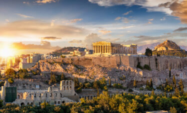 Panoramic view of the Acropolis and Parthenon in Athens at sunset, a highlight of any Athens city break.