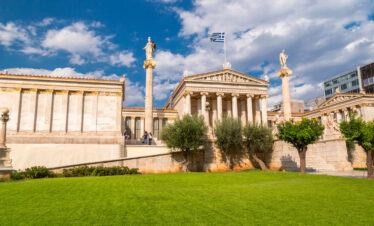 Neoclassical Academy of Athens under a blue sky, symbolizing the heritage of Classical Greece and ancient landmarks.