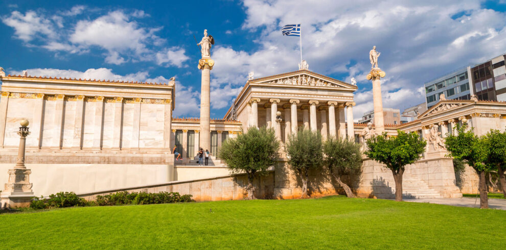 Neoclassical Academy of Athens under a blue sky, symbolizing the heritage of Classical Greece and ancient landmarks.