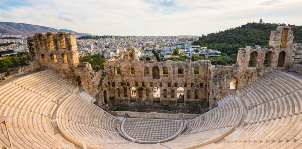 The ancient Odeon of Herodes Atticus amphitheater on the Acropolis hill with panoramic views of Athens city.