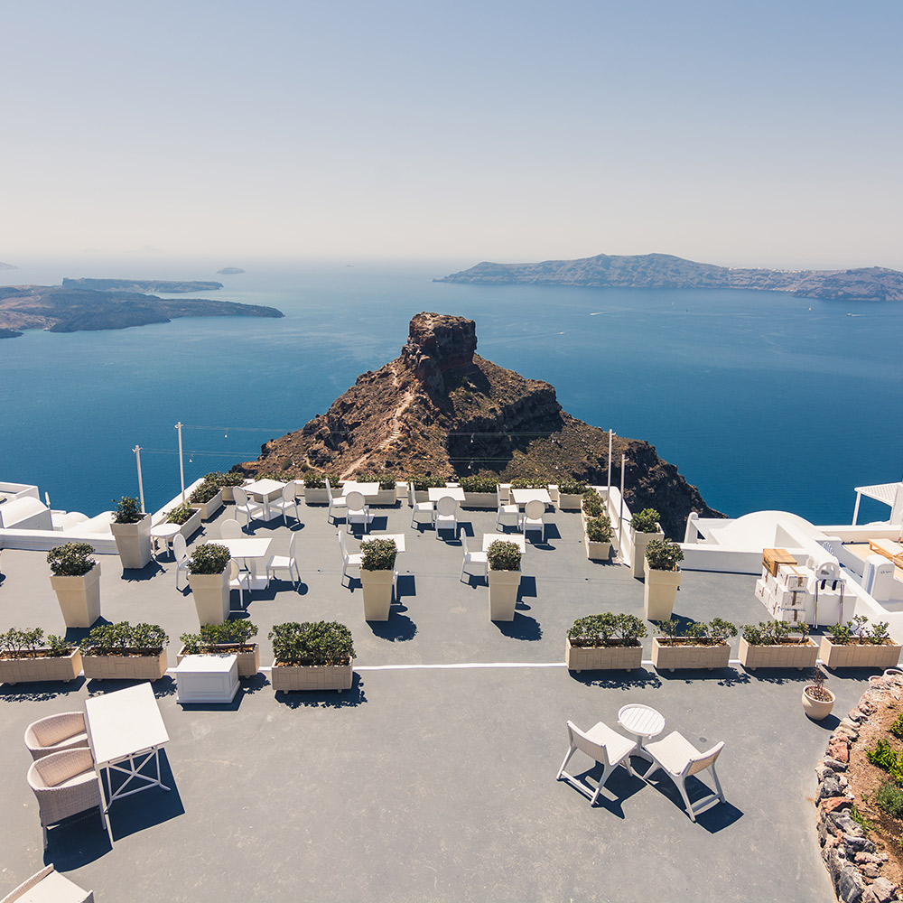 Modern meeting terrace with panoramic caldera views in Santorini, ideal for corporate events and strategic gatherings.