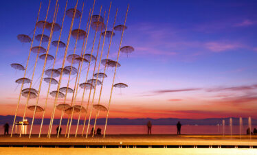 Umbrellas sculpture on Thessaloniki waterfront at sunset, iconic landmark of Northern Greece city breaks.