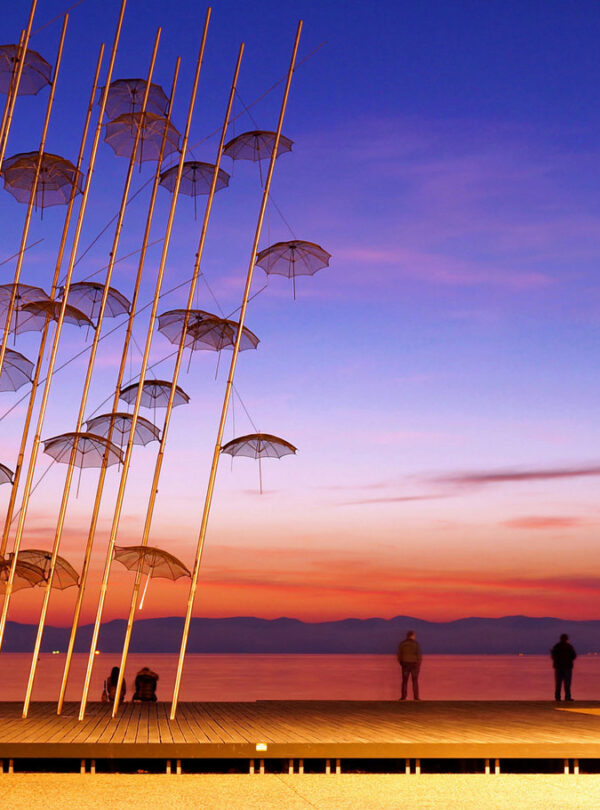 Umbrellas sculpture on Thessaloniki waterfront at sunset, iconic landmark of Northern Greece city breaks.
