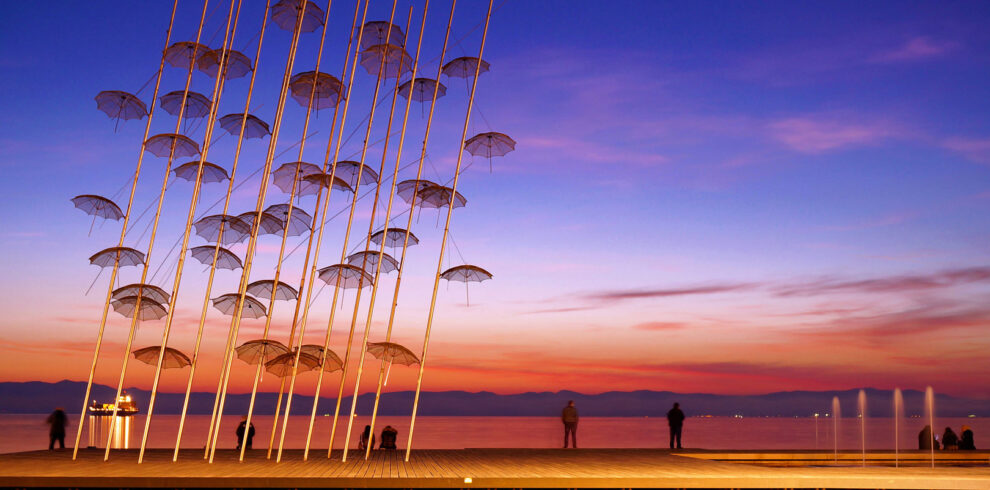 Umbrellas sculpture on Thessaloniki waterfront at sunset, iconic landmark of Northern Greece city breaks.