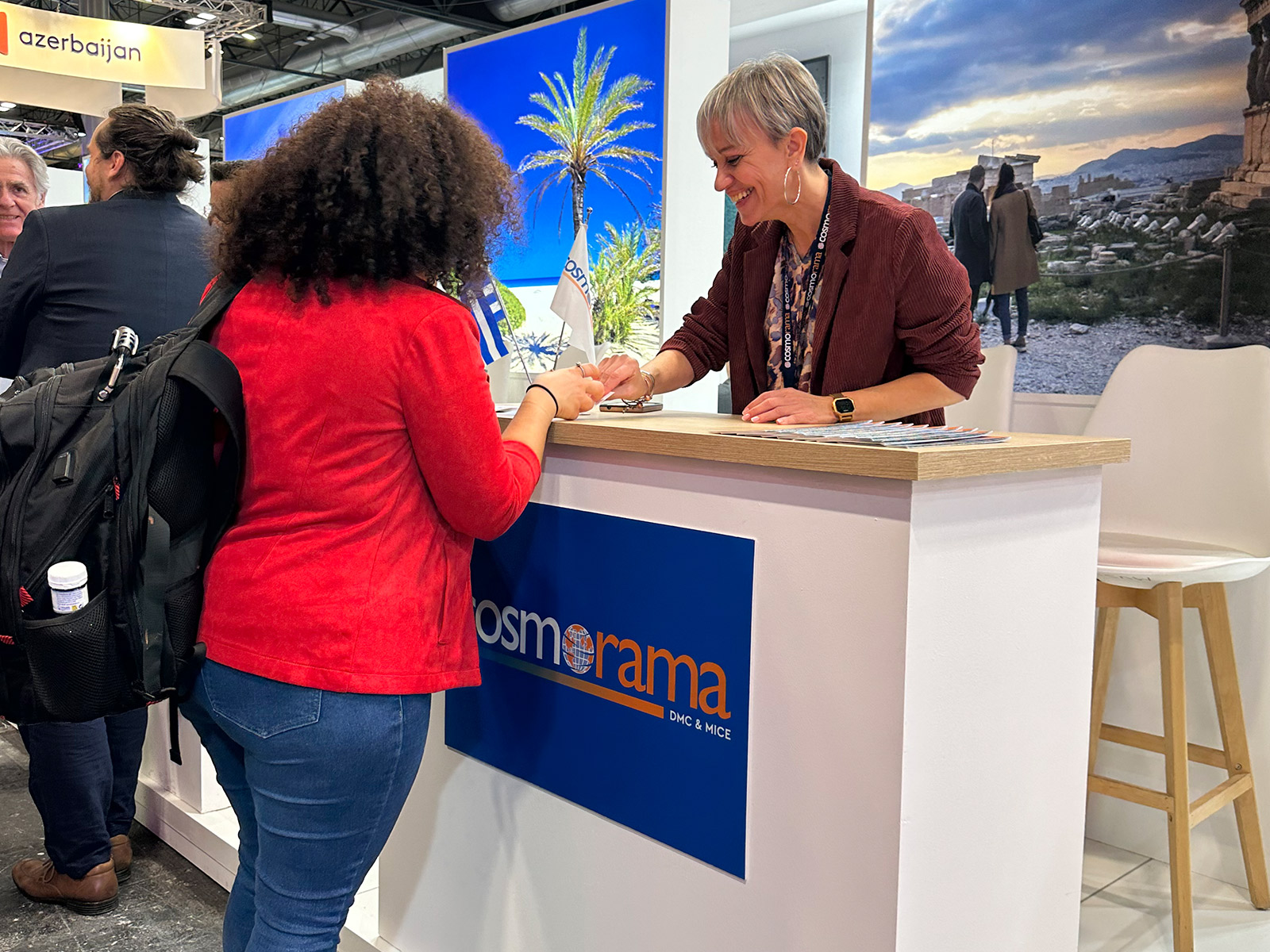 Cosmorama DMC representative engaging with visitors and presenting Greece travel programs at FITUR 2026 in Madrid.