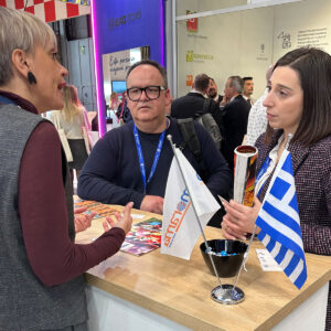 Cosmorama DMC team discussing Greece travel opportunities with international partners at FITUR 2026 tourism fair in Madrid.